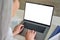 Female older businesswoman typing on laptop computer keyboard with empty screen.