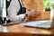 A female online business startup managing her shipping orders in the office. cropped image