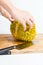 Female opening durian fruit on wooden board