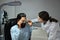 Female ophthalmologist testing vision or sight of male patient with special ophthalmic glasses in ophthalmology clinic