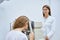 Female optometrist checking woman eyes with autorefractor