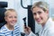 Female optometrist examining young patient with ophthalmoscope