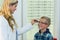 Female optometrist prescribing spectacles to young patient