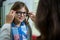 Female optometrist prescribing spectacles to young patient