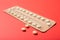 Female oral contraceptive pill blister on a red background background
