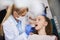 Female orthodontist examining child`s teeth