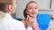 Female orthodontist examining child`s teeth in dentist`s office