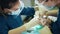 Female orthodontist wearing face mask and protective face shield at work