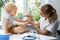 Female orthopedist examining little child foot condition in clinic