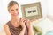 Female Owner Holding Framed Open Sign In Bedding Store