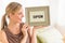 Female Owner Holding Open Sign In Bedding Store