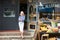 Female Owner Standing Next To Produce Display At Deli