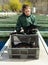 Female owner of sturgeon farm showing fish