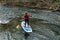 Female Paddle Boarder Wearing Safety Harness Floating on the Roanoke River