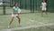 Female paddle tennis player during couple match at court