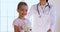 Female paediatrician embrace happy cute child girl look at camera