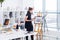 Female painter drawing in art studio using easel. Portrait of a young woman painting with aquarelle paints on white