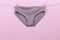 Female panties hanging on rope on pastel background - Image  - Image