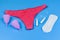 Female panty, tampons, menstrual cup and sanitary pad isolated on a blue background. Woman hygiene