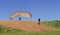 Female paraglider pilot taking off and woman filming with her mobile