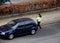 FEMALE PARKING INSPECTOR CHECKING PARKING PERMISSION