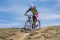 Female participant cycling down over hill during first amateurs` spring race of a local bicycle club in Dnipr