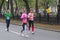 Female participants exchanging with drink bottles while running on Dnipro city street during 42 km distance of ATB Dnipro Marathon