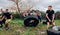 Female participants in an obstacle course turning a wheel