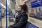 Female passenger wearing face covering mask during covid-19 lockdown inside metro train in england uk