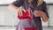 A female pastry chef pours red covering on the cake at her kitchen