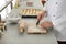 Female pastry chef preparing croissant at table in kitchen