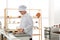 Female pastry chef preparing croissants at table