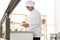 Female pastry chef preparing croissants at table