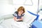 Female patient with abdominal pain on bed in hospital ward