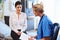 Female Patient And Doctor Have Consultation In Hospital Room