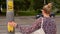 Female pedestrian presses traffic light button to cross road, hygiene standards.