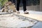 Female pedestrians people is walking on a footpath walkway under construction and stacked cobblestone block or renovation,damaged