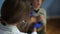 Female pediatrician checks a childs health, lungs and heartbeat using a phonendoscope. Close-up, curly boy coughing. The