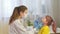 Female pediatrician doctor examines a little girl. A nurse examines a child\'s throat in a private clinic. doctor