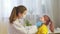 Female pediatrician doctor examines a little girl. A nurse examines a child\'s throat in a private clinic. doctor