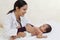 Female pediatrician holds newborn baby