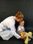 Female pediatrician playing with boy listening teddy bear by stethoscope