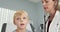 Female pediatrician using stethoscope to listen to breathing of little boy
