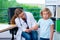 Female pediatrician in white lab coat examined little patient