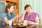 Female pensioner having conversation with her daughter