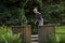 A female pensioner minigolf player in position to hit the ball o