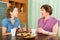 Female pensioner tea-drinking with her daughter