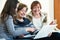 Female pensioners and relative browsing web on laptop