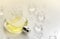 Female perfume yellow bottle, Objective photograph of perfume bottle in ice cubes and water on white table. View from