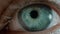 Female person closes turquoise eye looking into camera